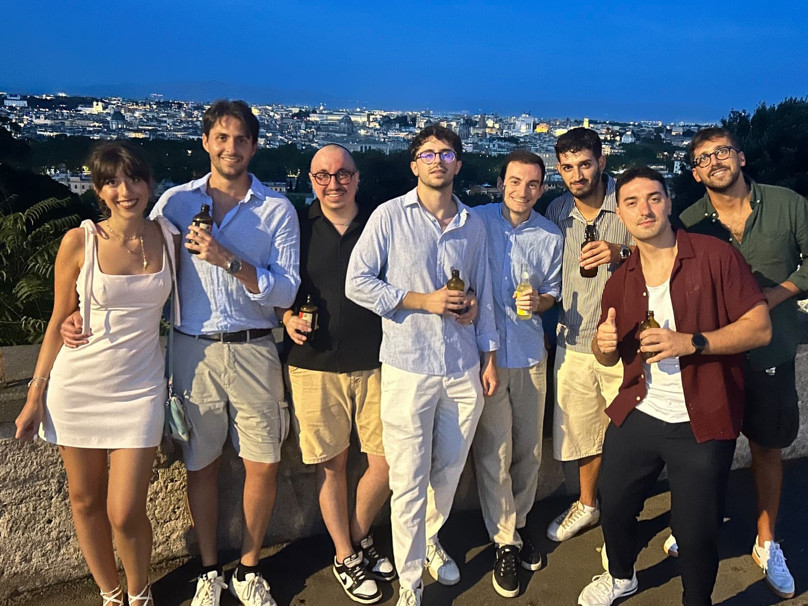 The team on a terrace overlooking Rome at dusk
